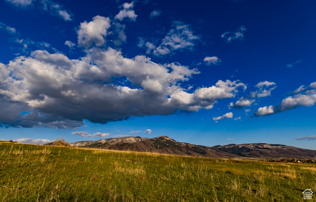 View of mountain backdrop with rural landscape