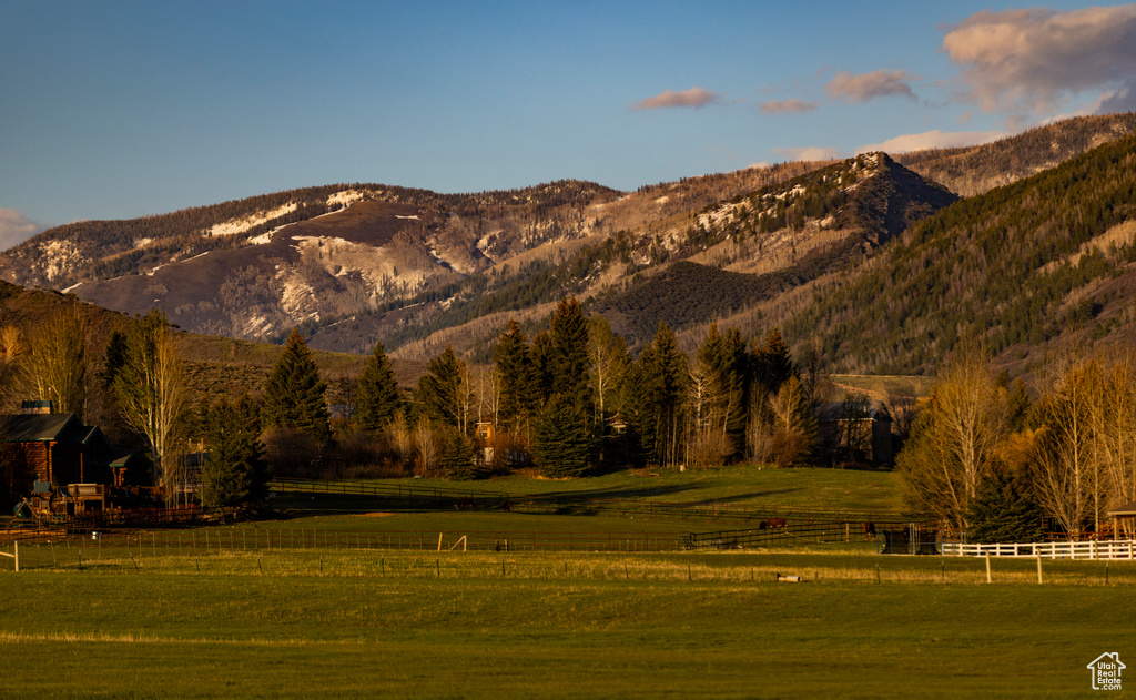 View of mountain backdrop with rural landscape and agricultural land