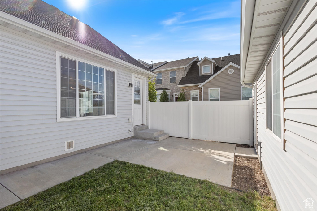 View of patio / terrace featuring fence, entry steps, and a residential view
