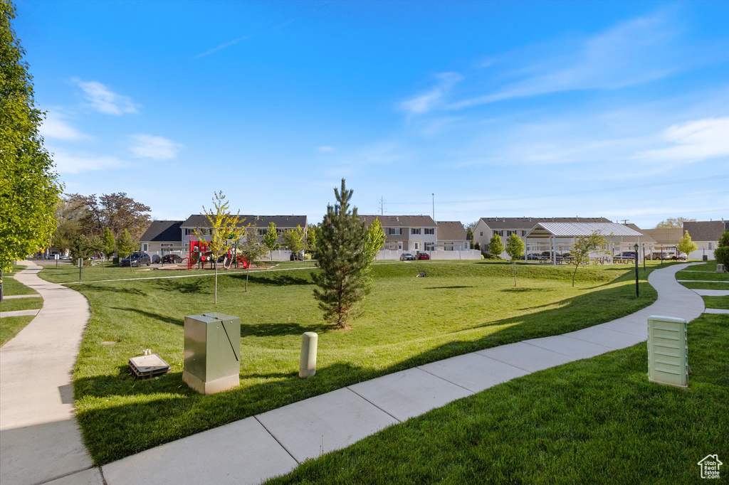 View of home's community with a residential view and a yard