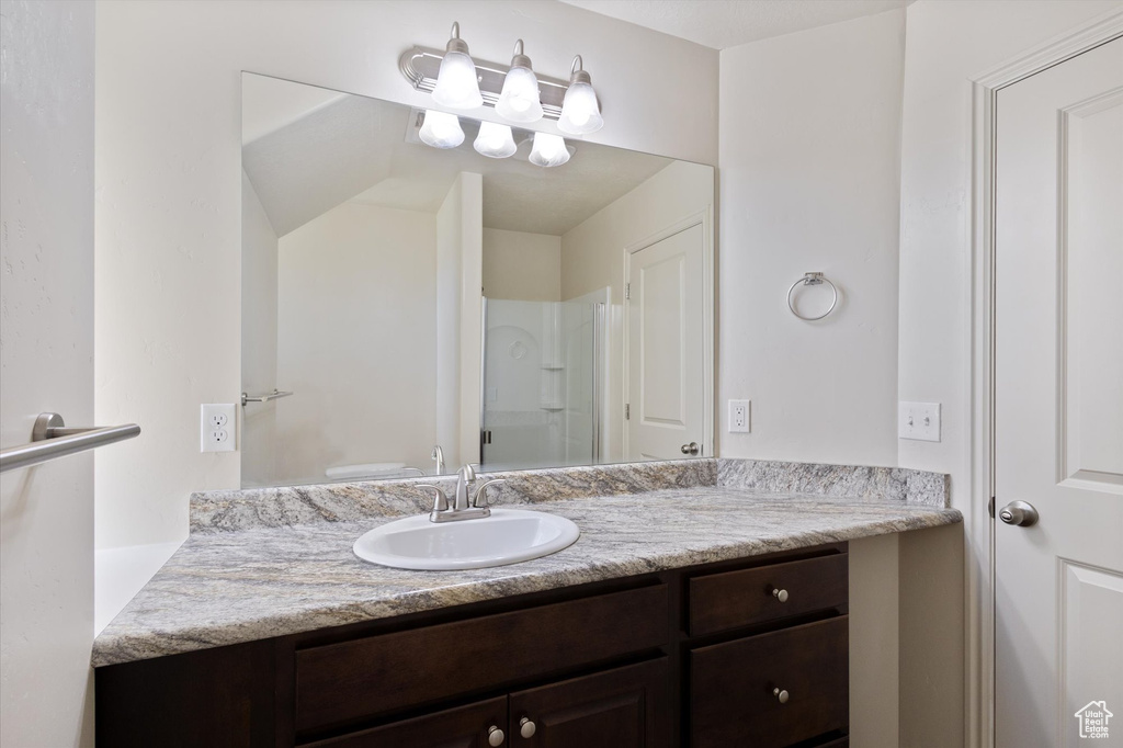 Bathroom with vanity and a shower