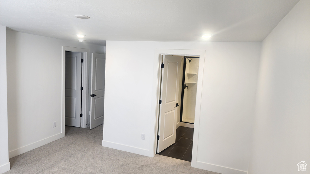 Unfurnished bedroom with carpet and baseboards