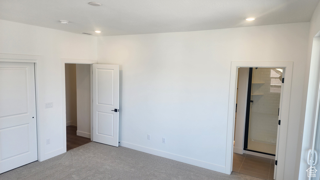 Unfurnished bedroom with carpet floors, baseboards, and recessed lighting