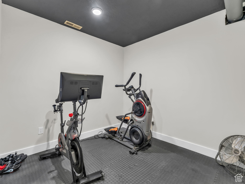 Workout area featuring baseboards and recessed lighting