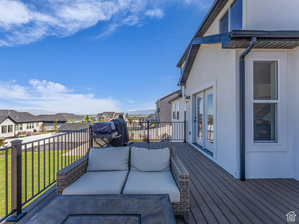 Wooden deck with a residential view and a lawn