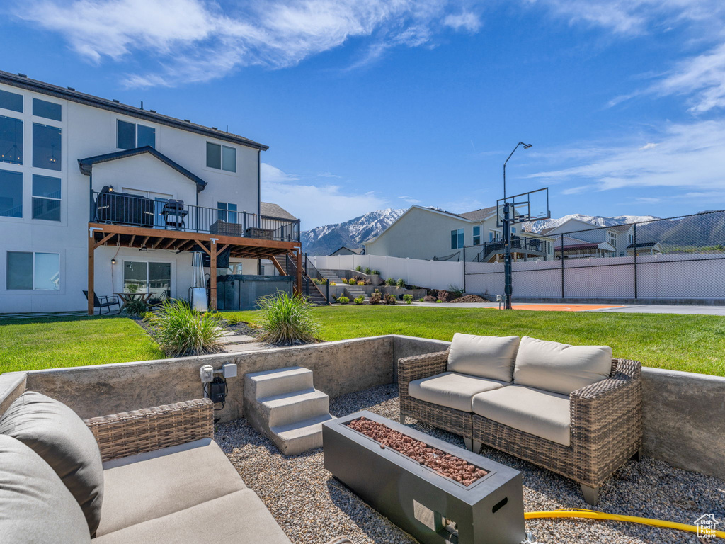 View of patio / terrace featuring an outdoor living space with a fire pit, stairway, a wooden deck, and a residential view