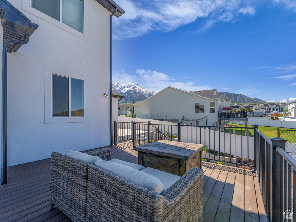 Wooden deck featuring a mountain view, a residential view, and outdoor lounge area