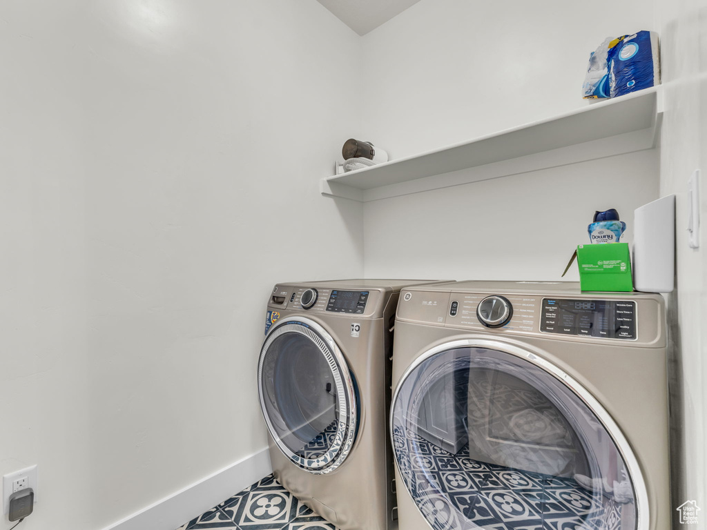 Clothes washing area with washing machine and dryer and baseboards