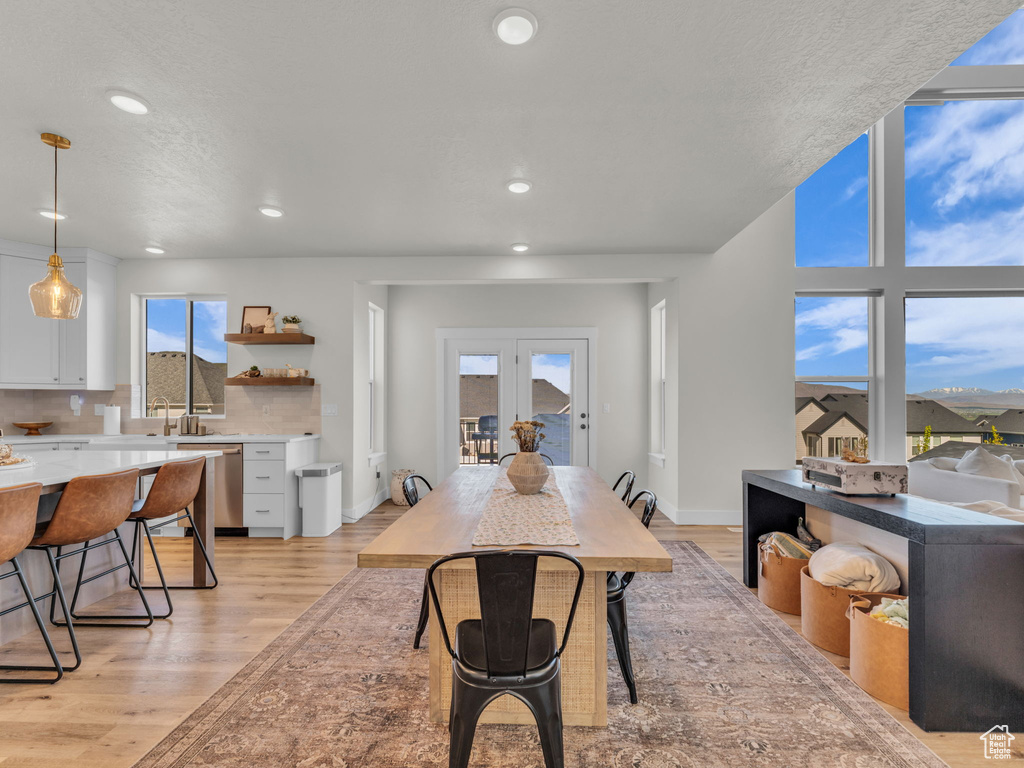Dining room featuring light wood-style flooring and recessed lighting