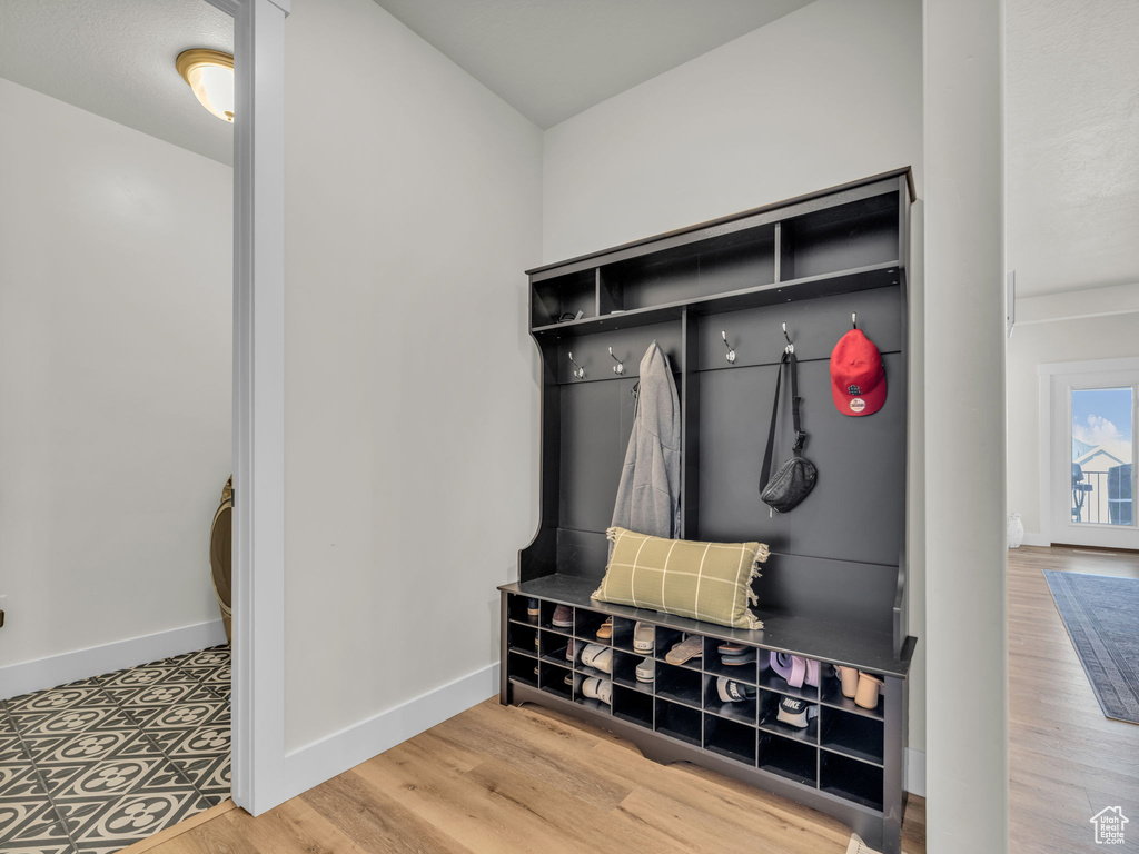 Mudroom featuring baseboards and wood finished floors