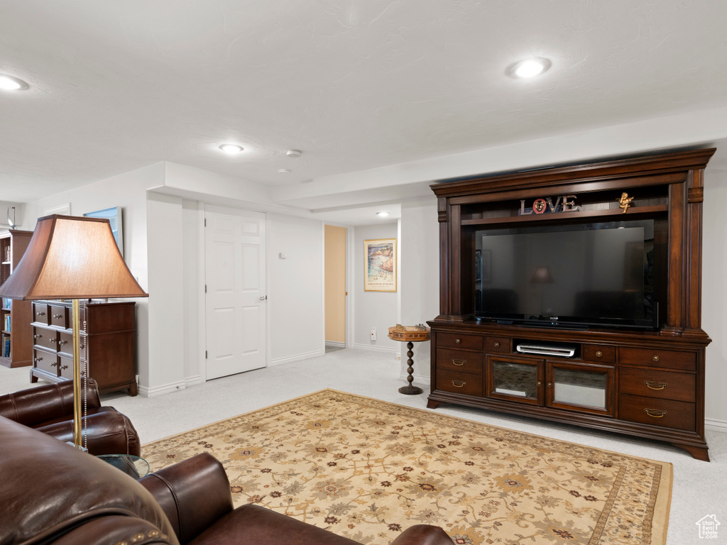Living room with carpet floors, baseboards, and recessed lighting