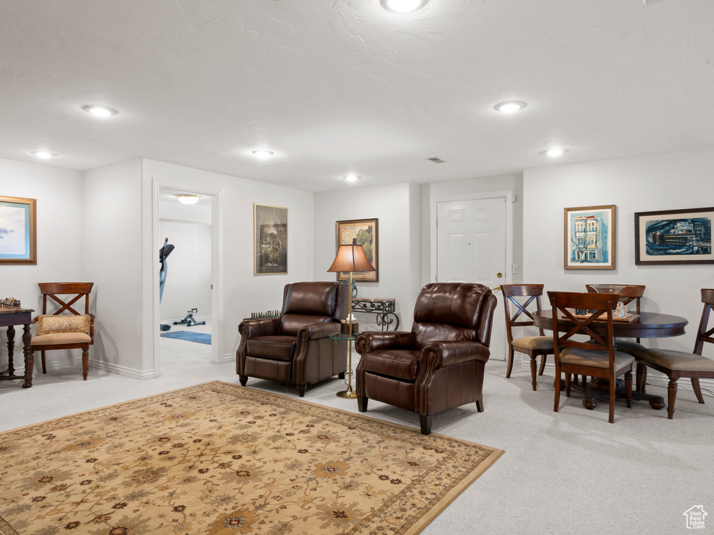 Living room with light carpet, recessed lighting, and baseboards