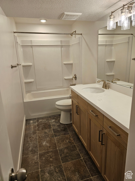 Full bathroom featuring a textured ceiling, toilet, vanity, washtub / shower combination, and recessed lighting