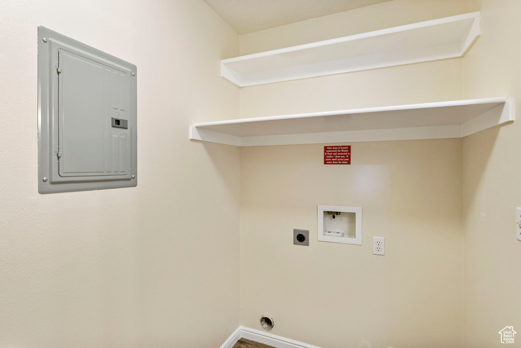Clothes washing area with electric panel, washer hookup, hookup for an electric dryer, and baseboards