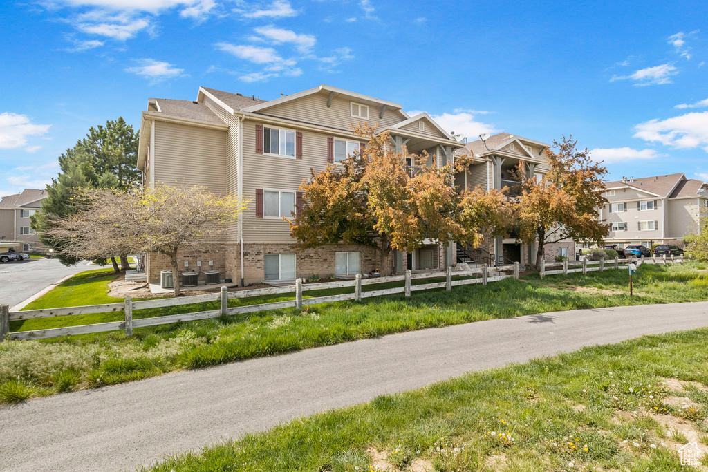 View of property with a fenced front yard and a residential view