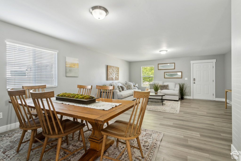 Dining space with baseboards and light wood-style floors
