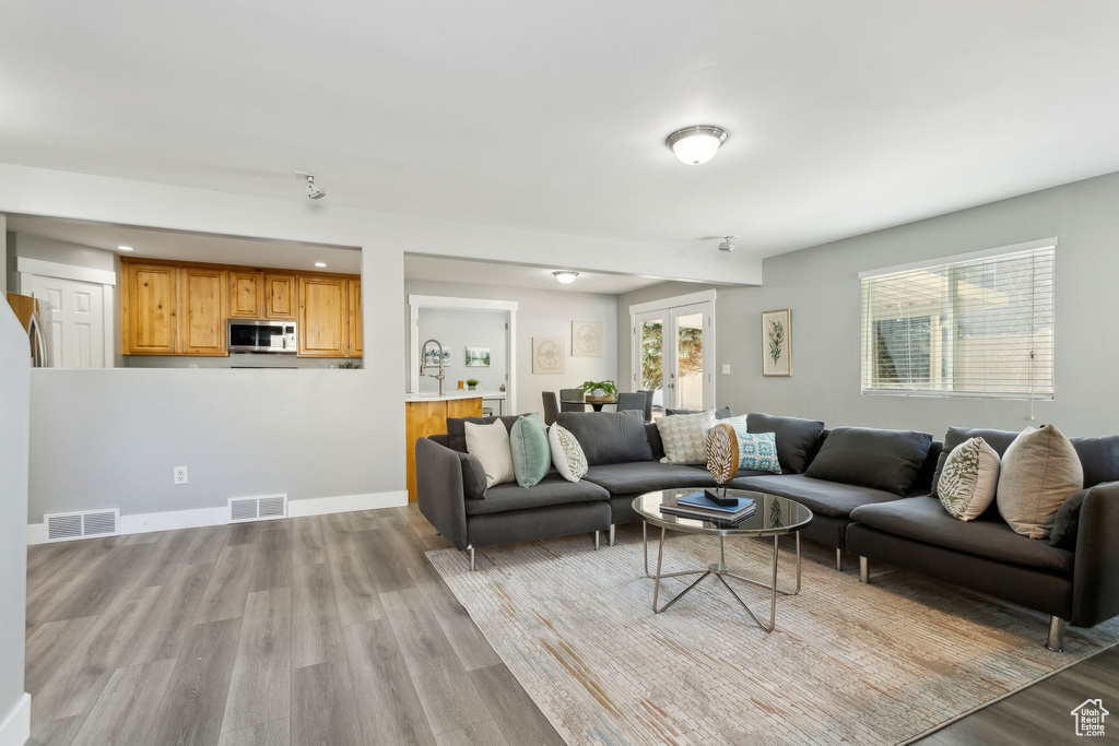 Living area featuring light wood finished floors and recessed lighting