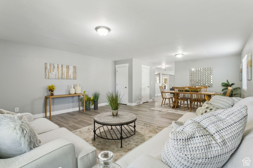 Living area with wood finished floors and baseboards