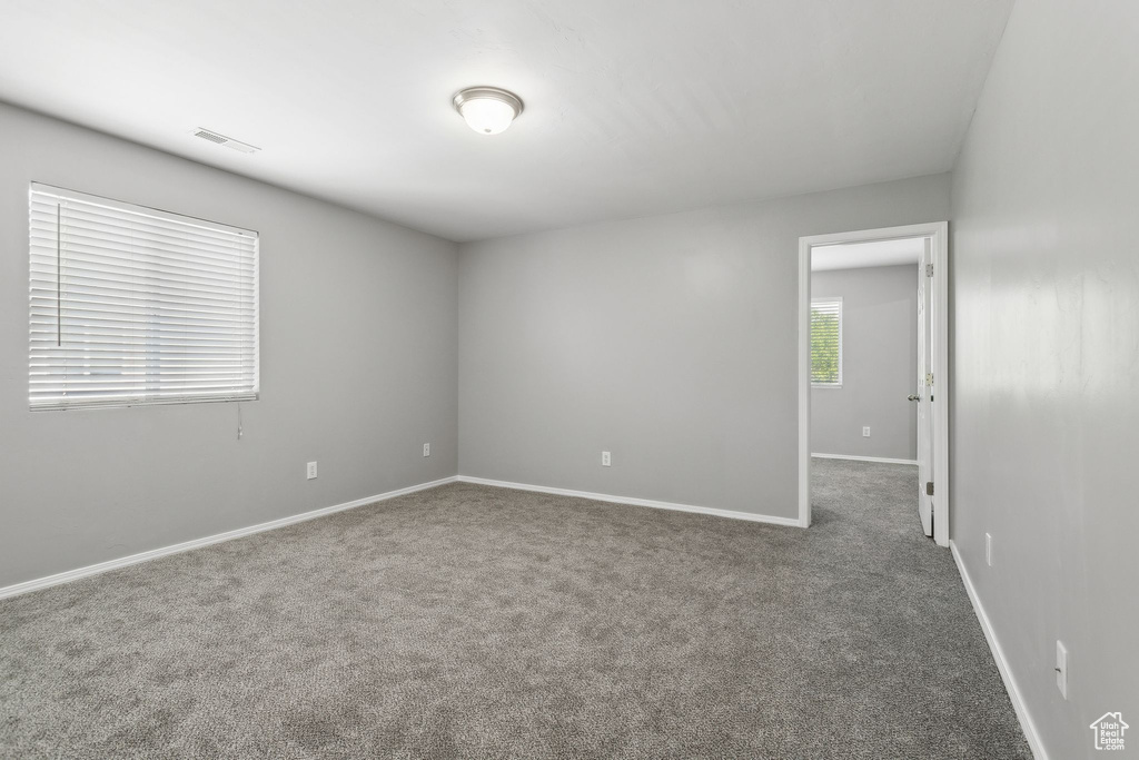 Unfurnished room with carpet and baseboards
