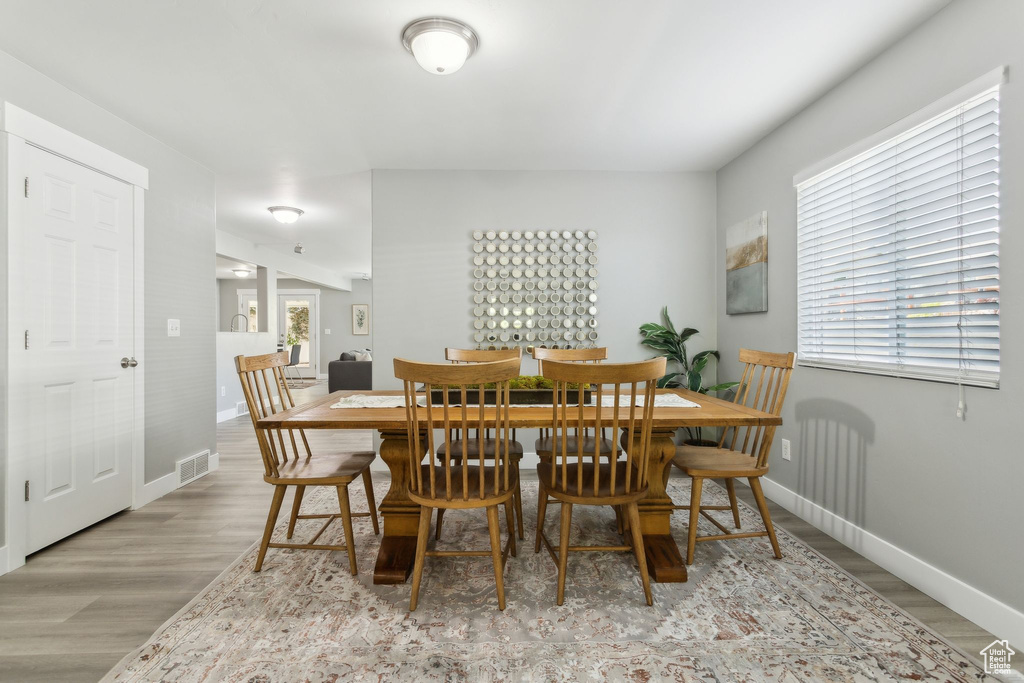 Dining space with wood finished floors and baseboards