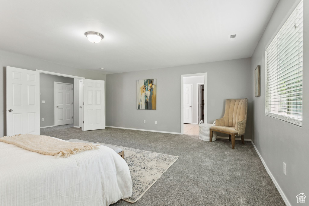 Bedroom featuring carpet and baseboards