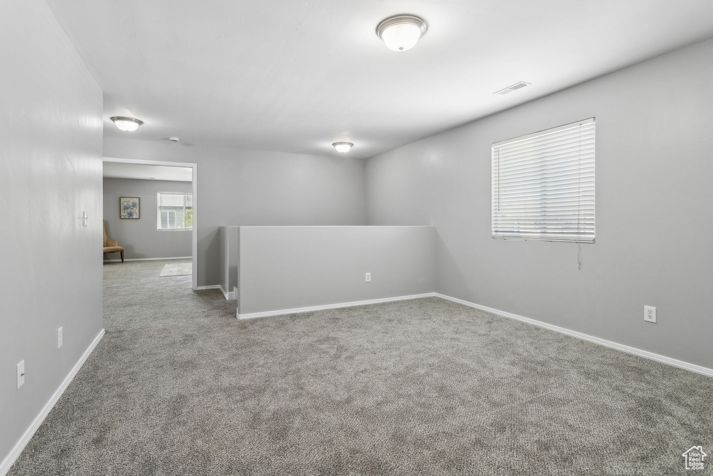 Empty room with carpet flooring and baseboards