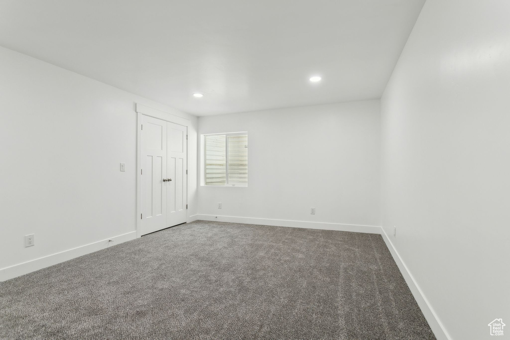 Carpeted empty room featuring recessed lighting and baseboards