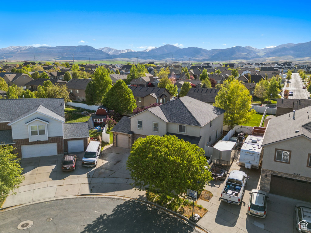 Aerial perspective of suburban area featuring a mountainous background