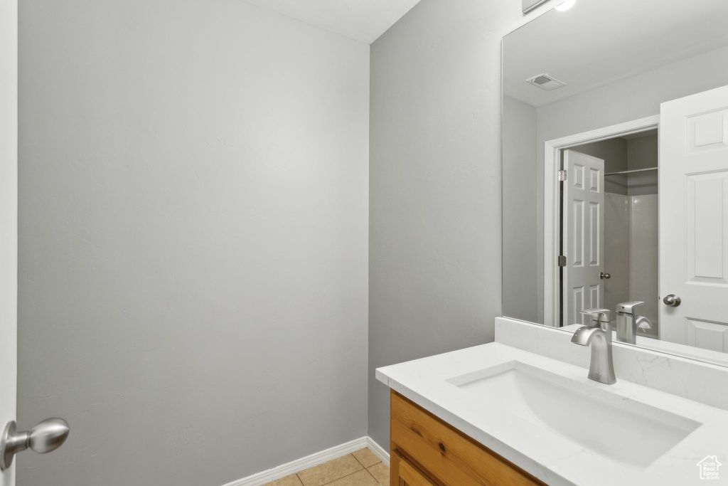 Bathroom with tile patterned flooring, baseboards, and vanity
