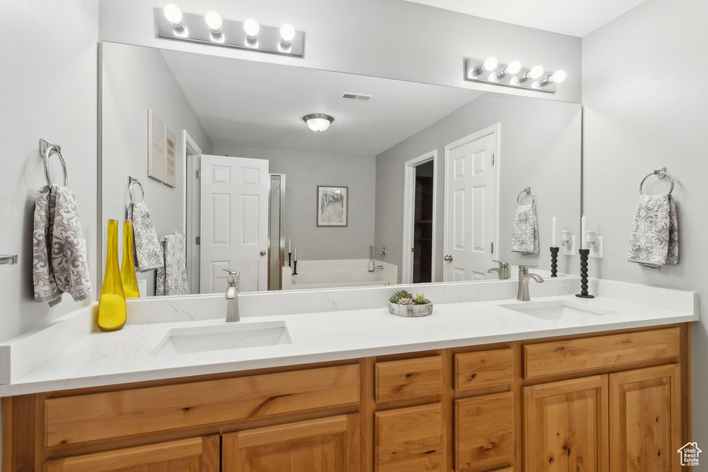 Full bath with double vanity and a bath