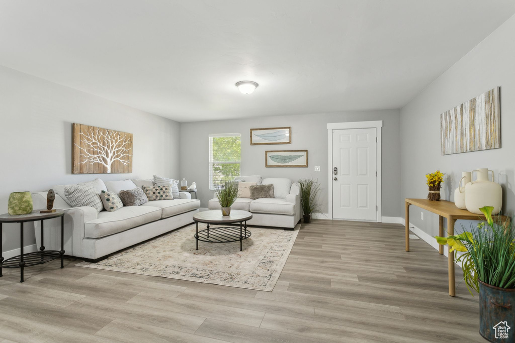 Living area with light wood-style flooring and baseboards