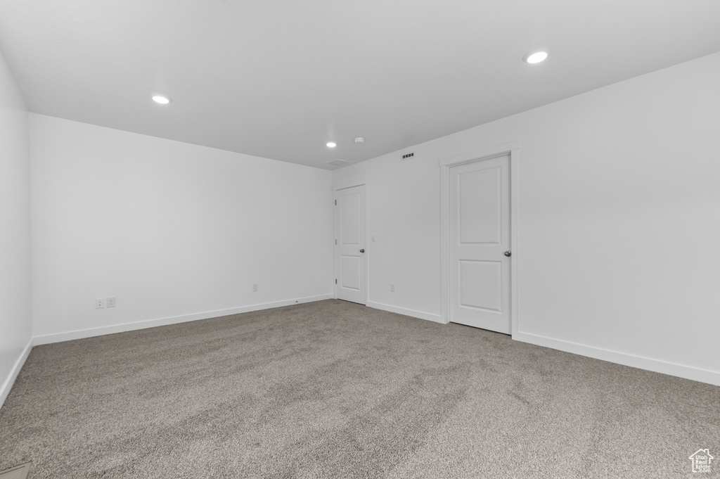 Unfurnished room with carpet floors, recessed lighting, and baseboards