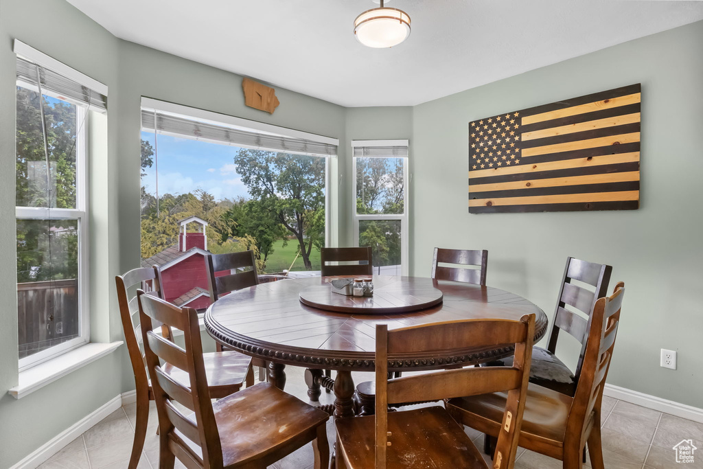 Dining space with baseboards and light tile patterned floors