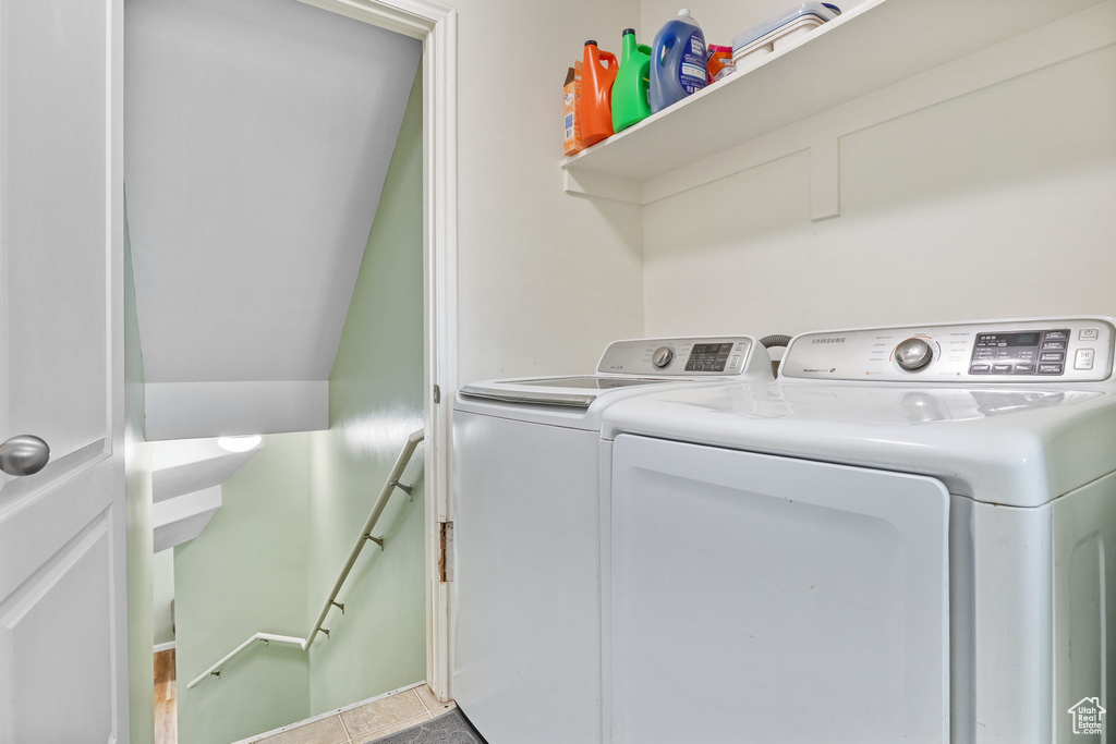 Clothes washing area featuring washing machine and clothes dryer