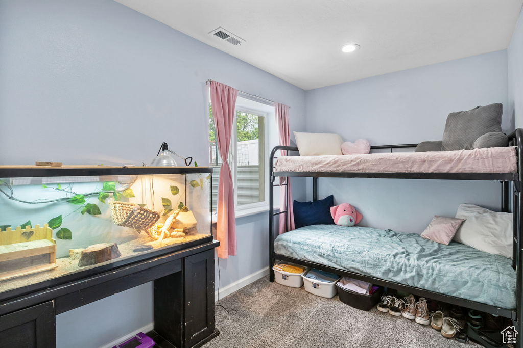Carpeted bedroom featuring baseboards