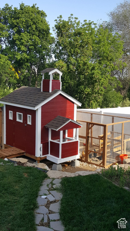 View of poultry coop featuring a yard