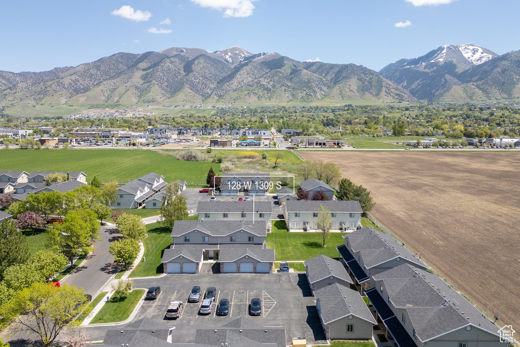Aerial overview of property\\\'s location featuring a mountainous background and nearby suburban area