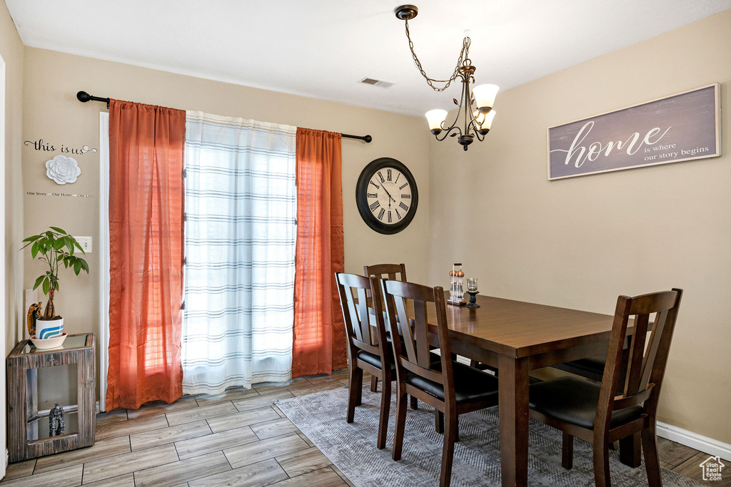 Dining room featuring a chandelier and light wood-style floors