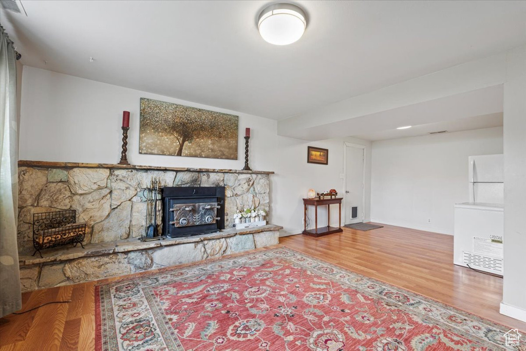 Living area with wood finished floors and a fireplace