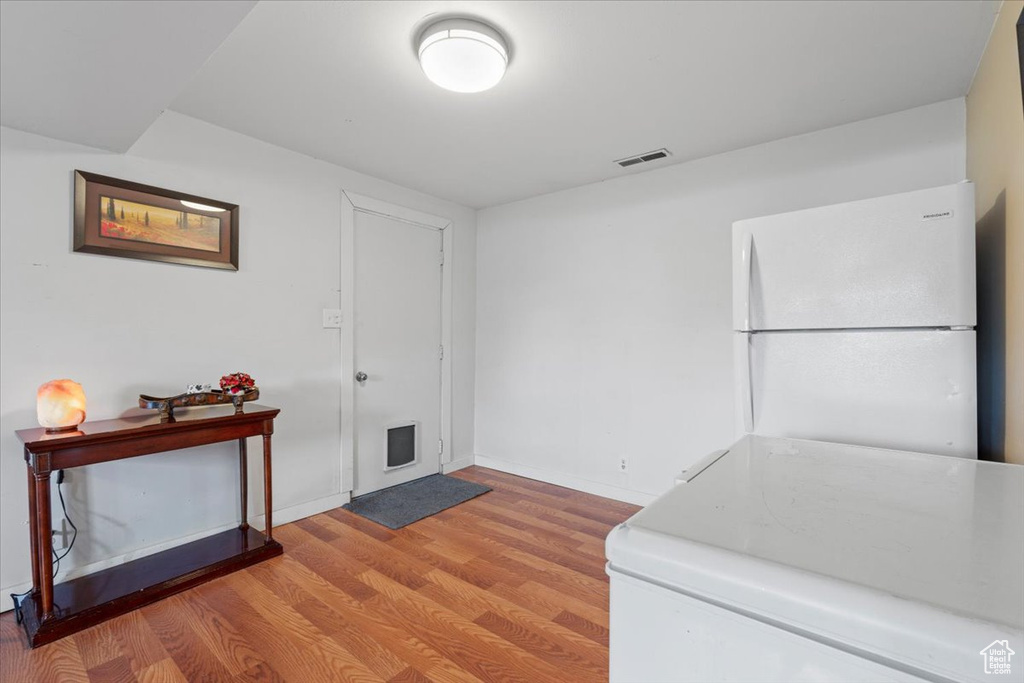 Foyer entrance featuring light wood-style floors and baseboards