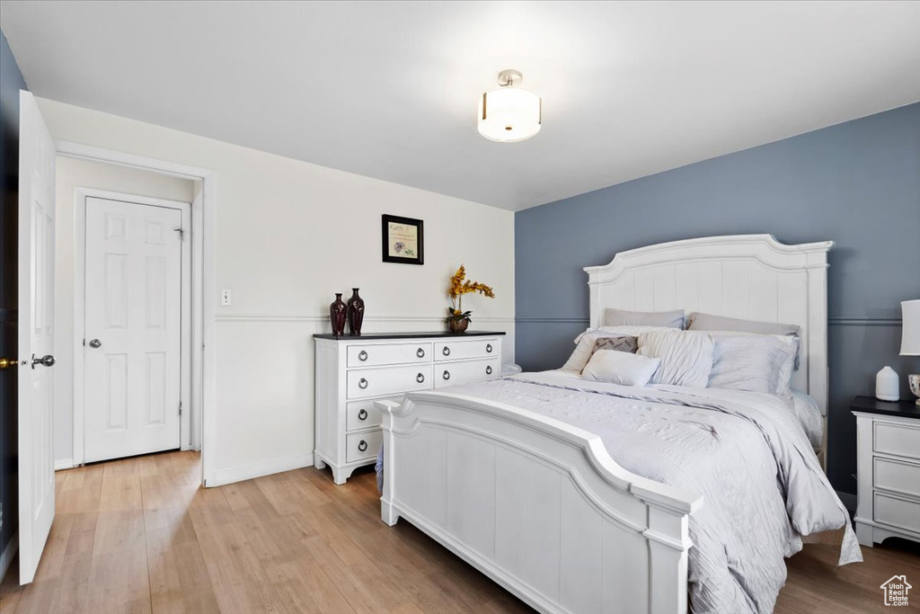 Bedroom with light wood finished floors and baseboards