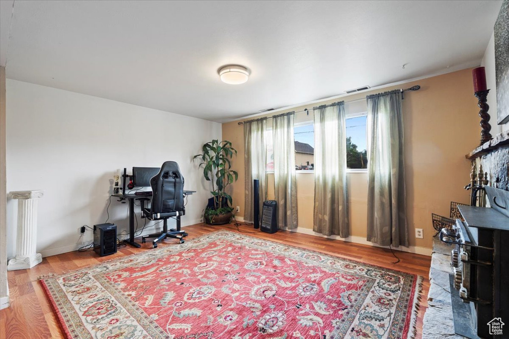Office area featuring wood finished floors, radiator, and baseboards