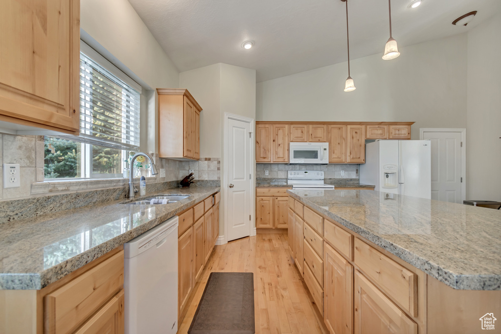 Kitchen featuring white appliances, a sink, light brown cabinets, light wood finished floors, and recessed lighting