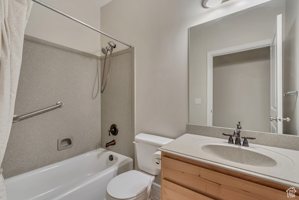 Full bathroom with toilet, vanity, and  shower combination