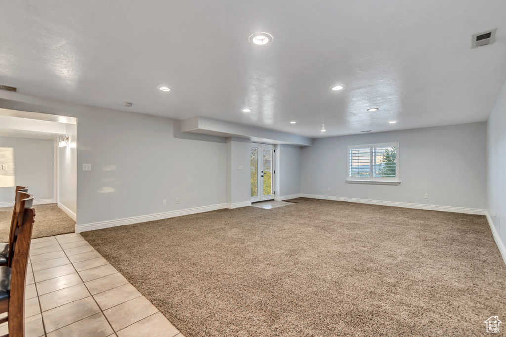 Below grade area featuring carpet, recessed lighting, baseboards, and tile patterned floors