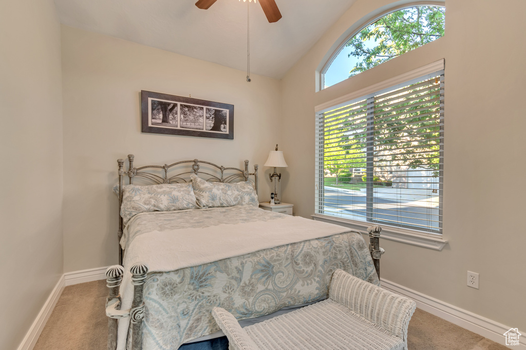 Bedroom featuring carpet flooring, lofted ceiling, baseboards, and ceiling fan
