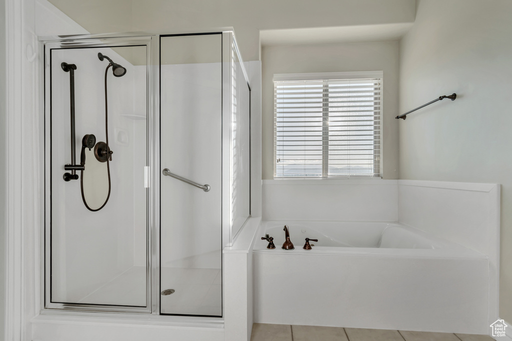 Full bathroom with a stall shower, a garden tub, and tile patterned flooring