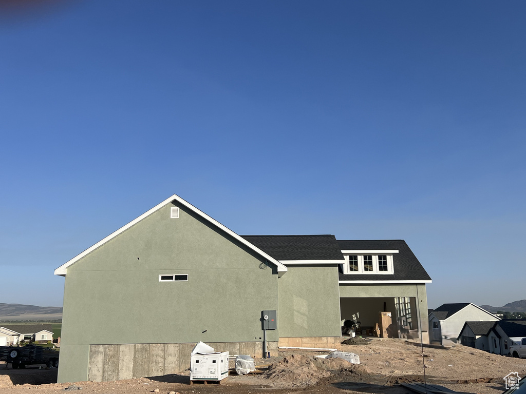View of side of home featuring stucco siding