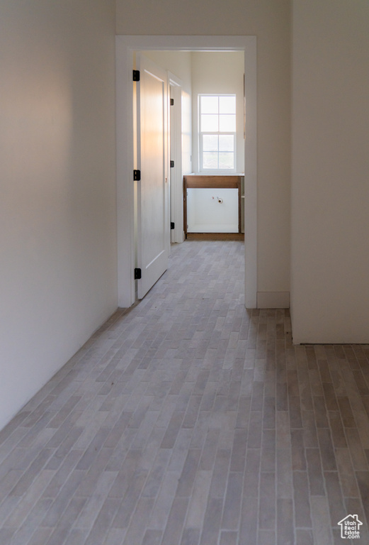Corridor featuring wood finished floors