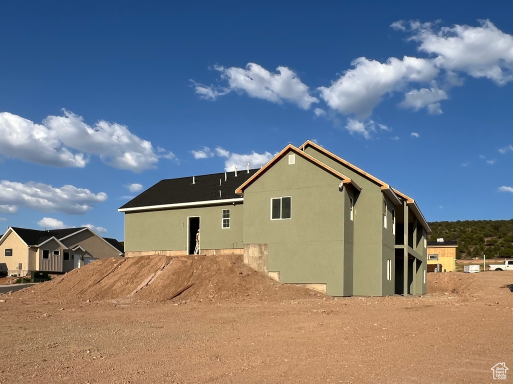 Back of property featuring stucco siding